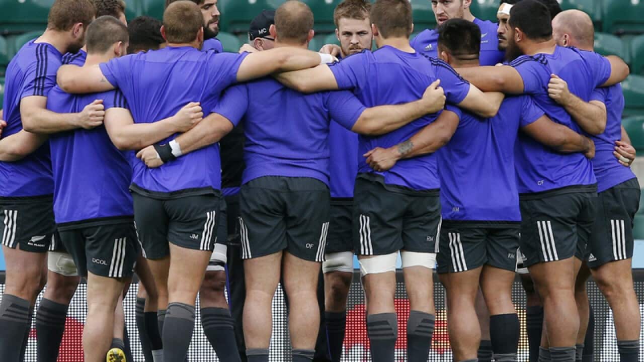 New Zealand players huddle during a training session at Twickenham