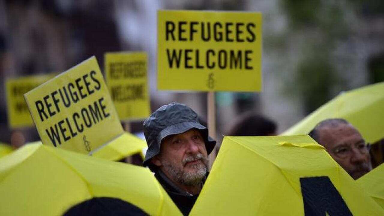 Members of Amnesty International take part in a protest in support of refugees and migrants, in Spain, last month