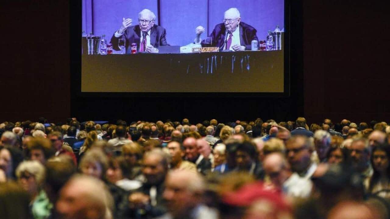 Shareholders in overflow rooms watch the meeting on big screens