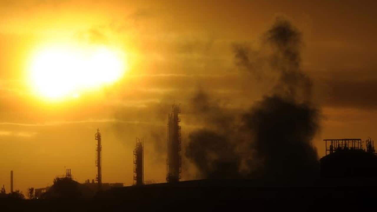 Steam and other emissions rise from an industrial plant