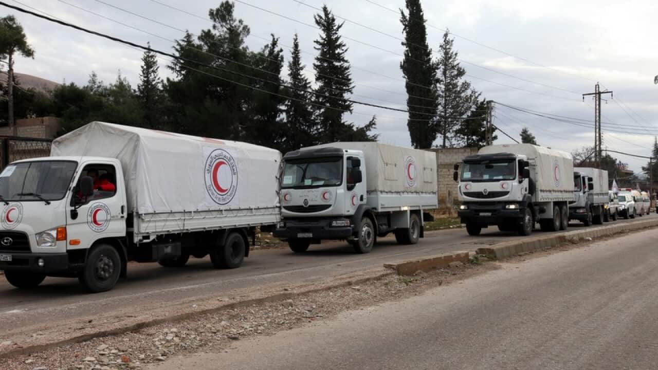 A convoy carrying food and blankets moves towards Madaya