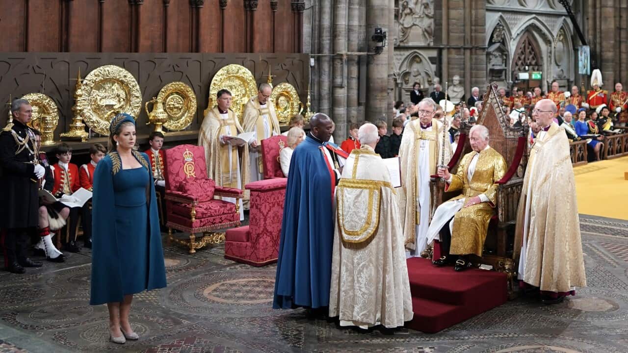 King Charles III holds the Sword of State during his coronation ceremony in Westminster Abbey