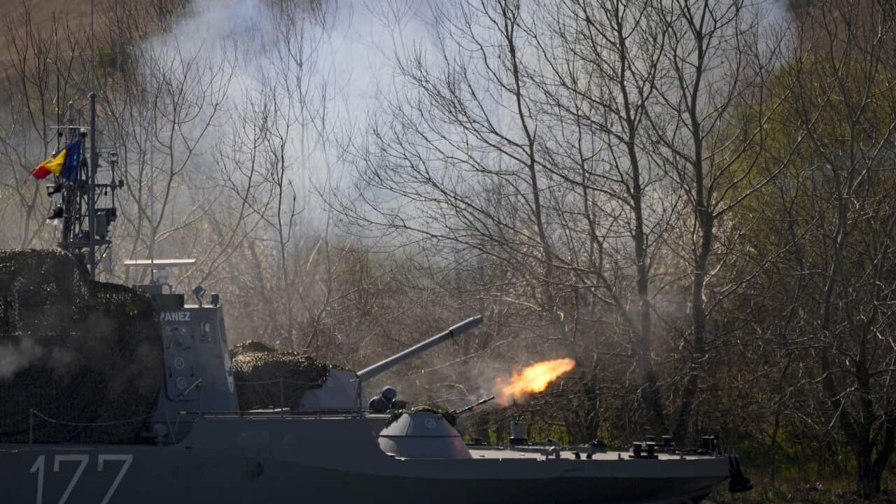 Servicemen fire a heavy machine gun from a warship on the river Danube during a Romanian Navy-led exercise outside Mahmudia, Romania.