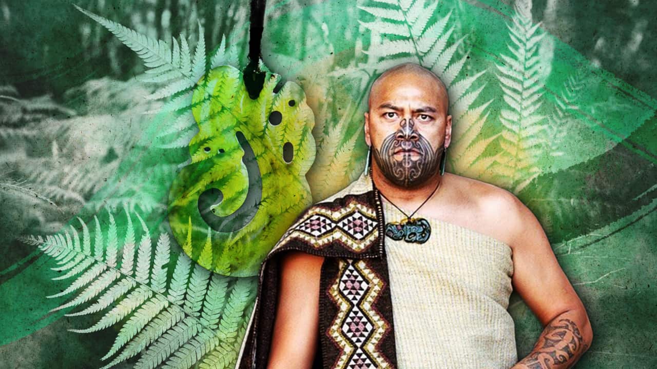 Hira Hona wearing a mataora and a traditional outfit, edited onto a green backdrop containing silver ferns and New Zealand greenstone.