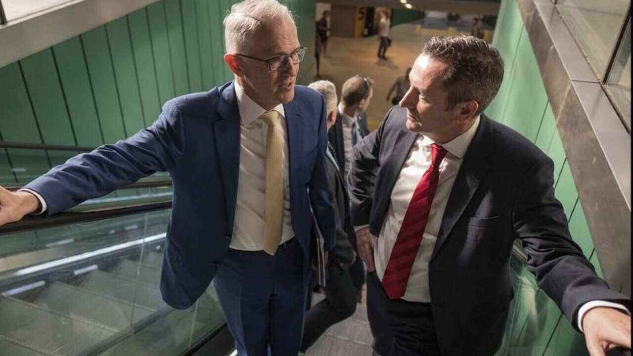 Malcolm Turnbull and Mark McGowan on an escalator