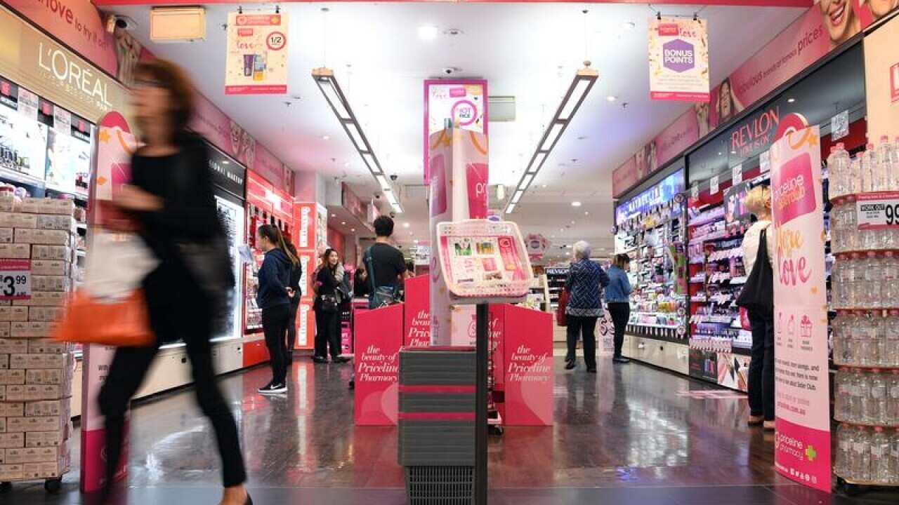 A shopper leaves a Priceline Pharmacy store