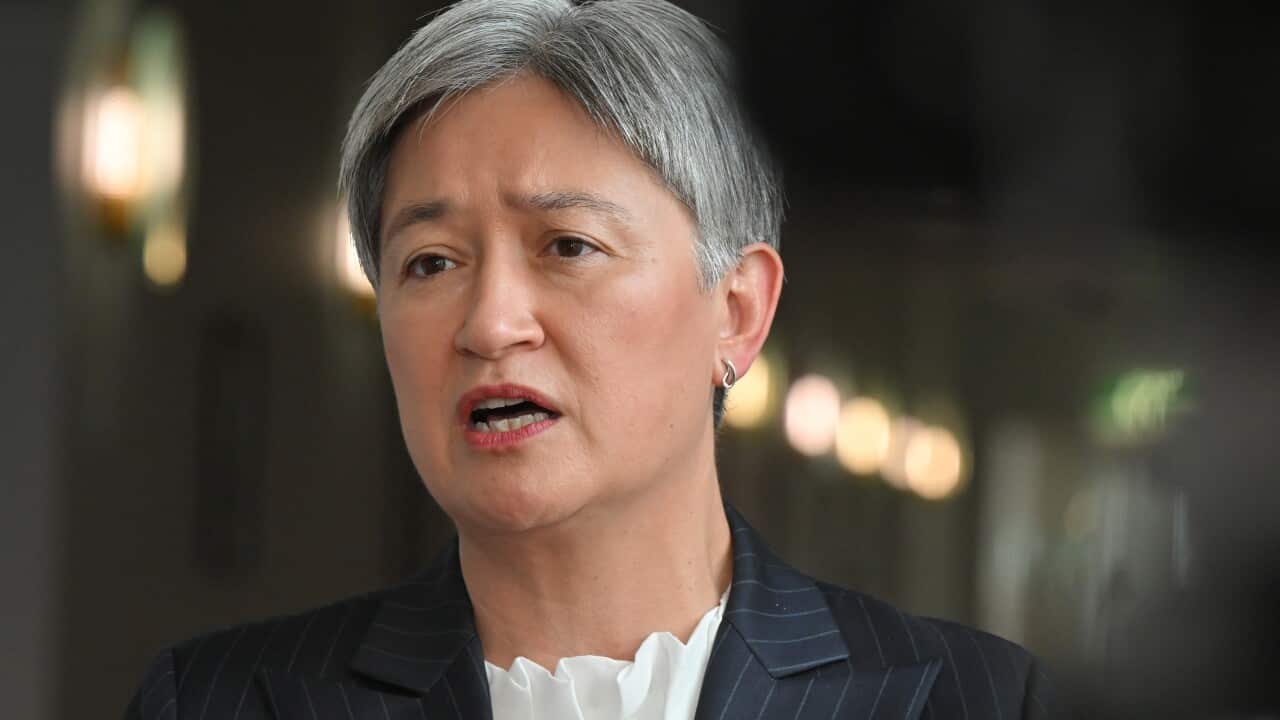 A woman with cropped silver hair in a black blazer