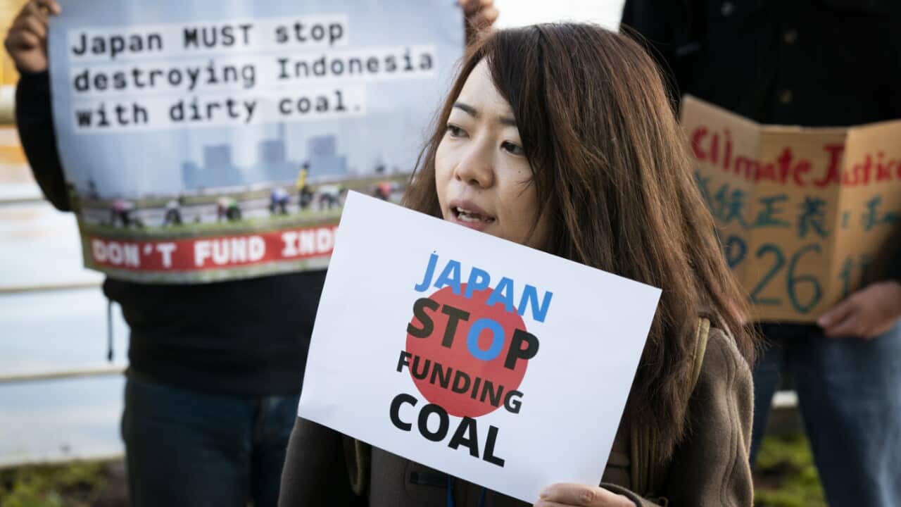 An activist from the No Coal Japan coalition protests at the COP26 in Glasgow.