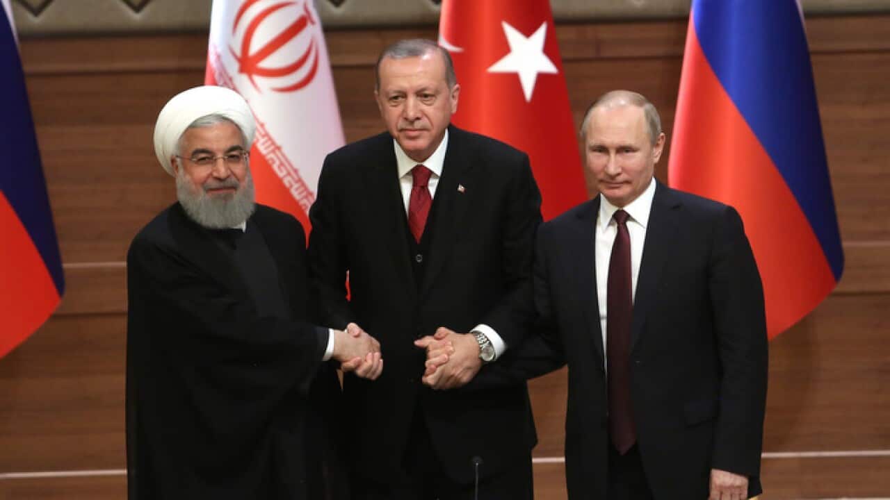 Iran's President Hassan Rouhani, left, Turkey's President Recep Tayyip Erdogan, centre, Russia's President Vladimir Putin, right