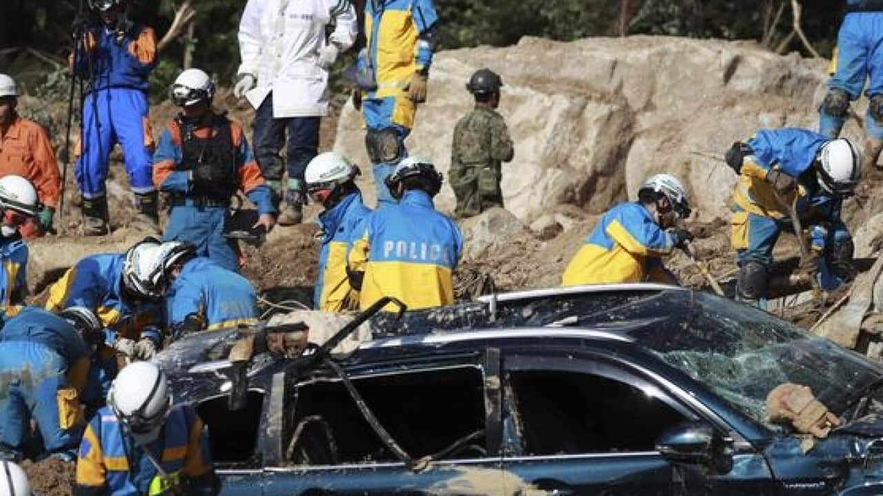 Rescuers search for missing people after a landslide.