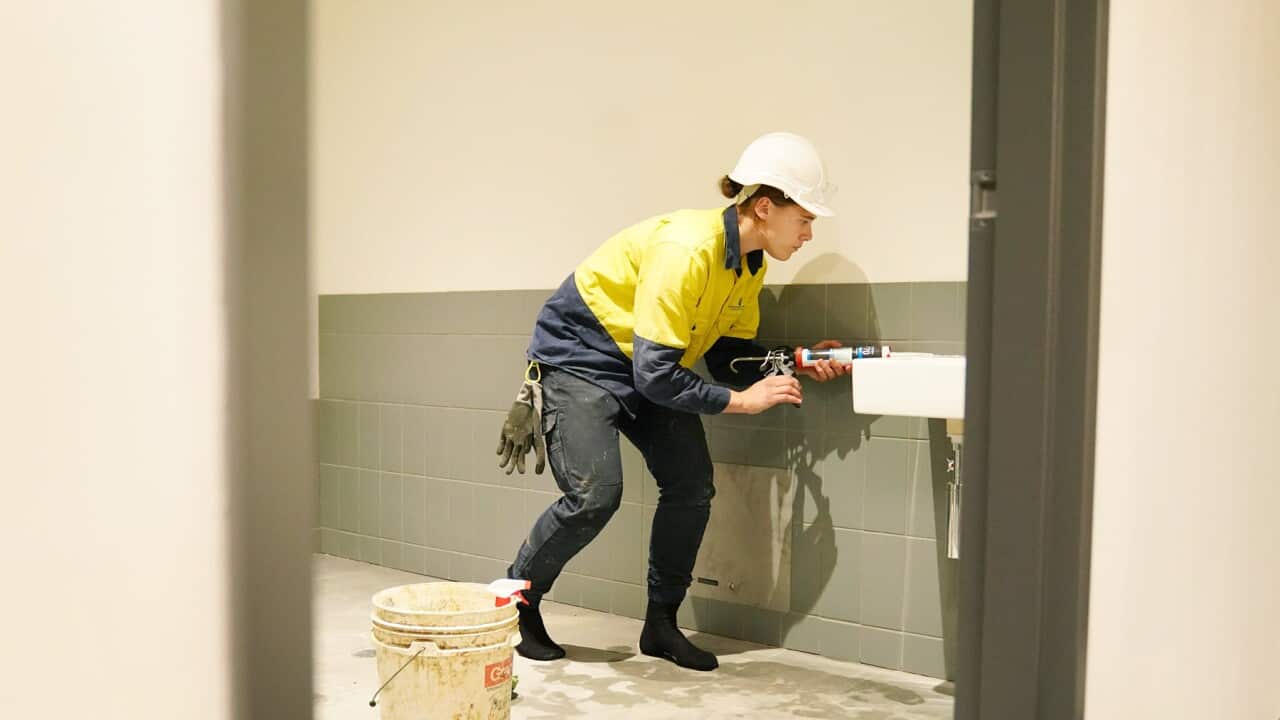 A female footy player plumber at a construction site in Melbourne (AAP).jpg
