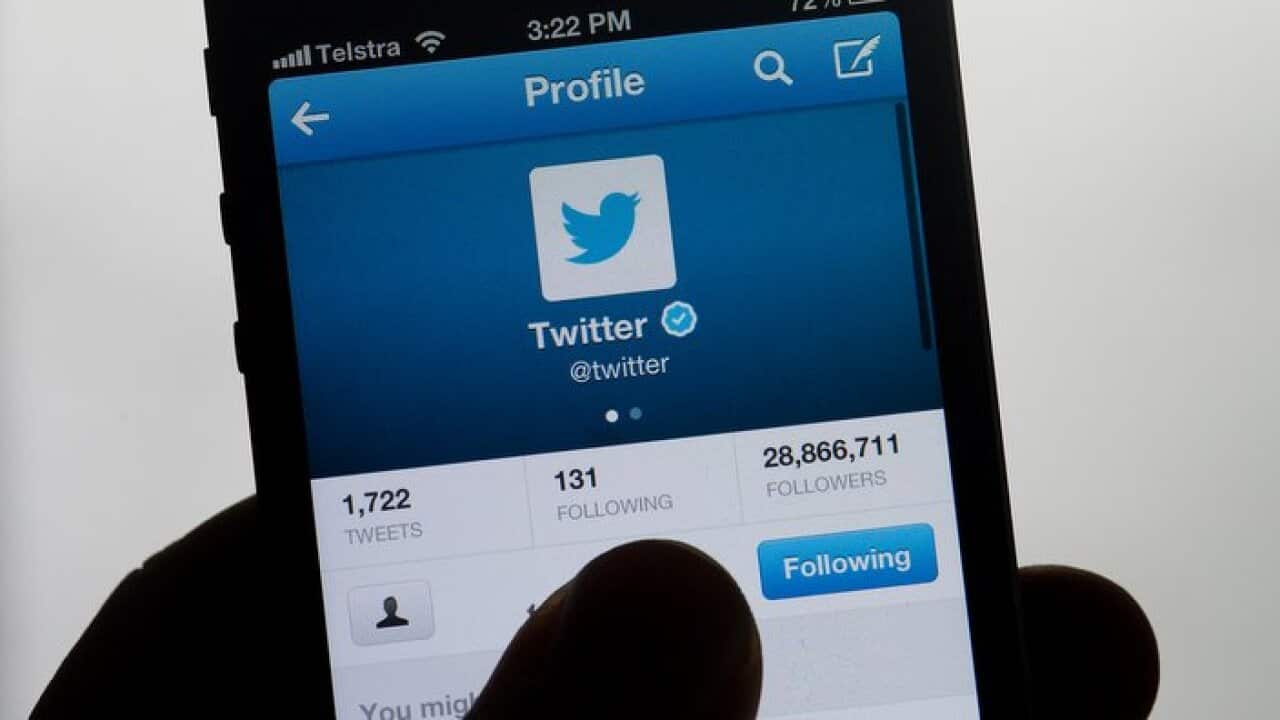 Stock photograph of the social networking site Twitter displayed on a hand held mobile phone., Friday, Feb. 14, 2014. (AAP Image/Dave Hunt) NO ARCHIVING