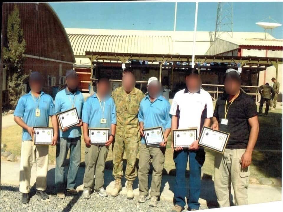 Wali* (second from right) worked as a cleaner at the Kandahar Air Field alongside Australian forces.