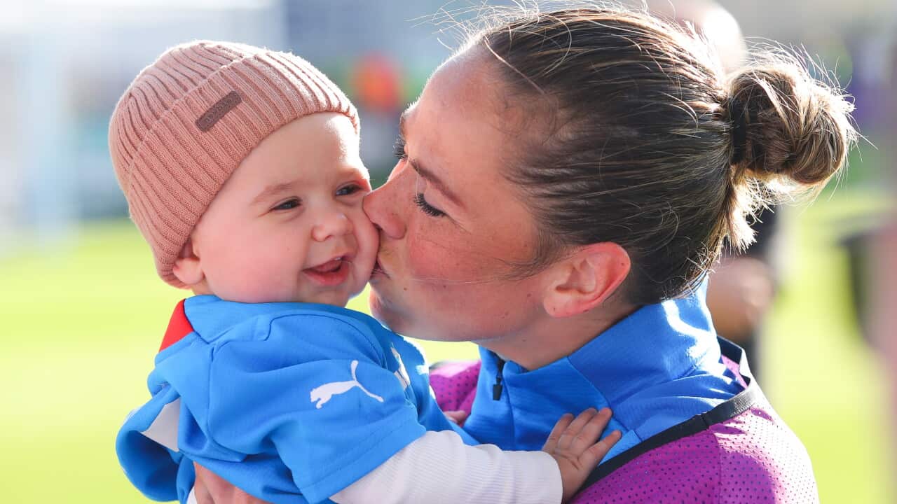 Sara Bjork Gunnarsdottir of Iceland embraces her son Ragnar