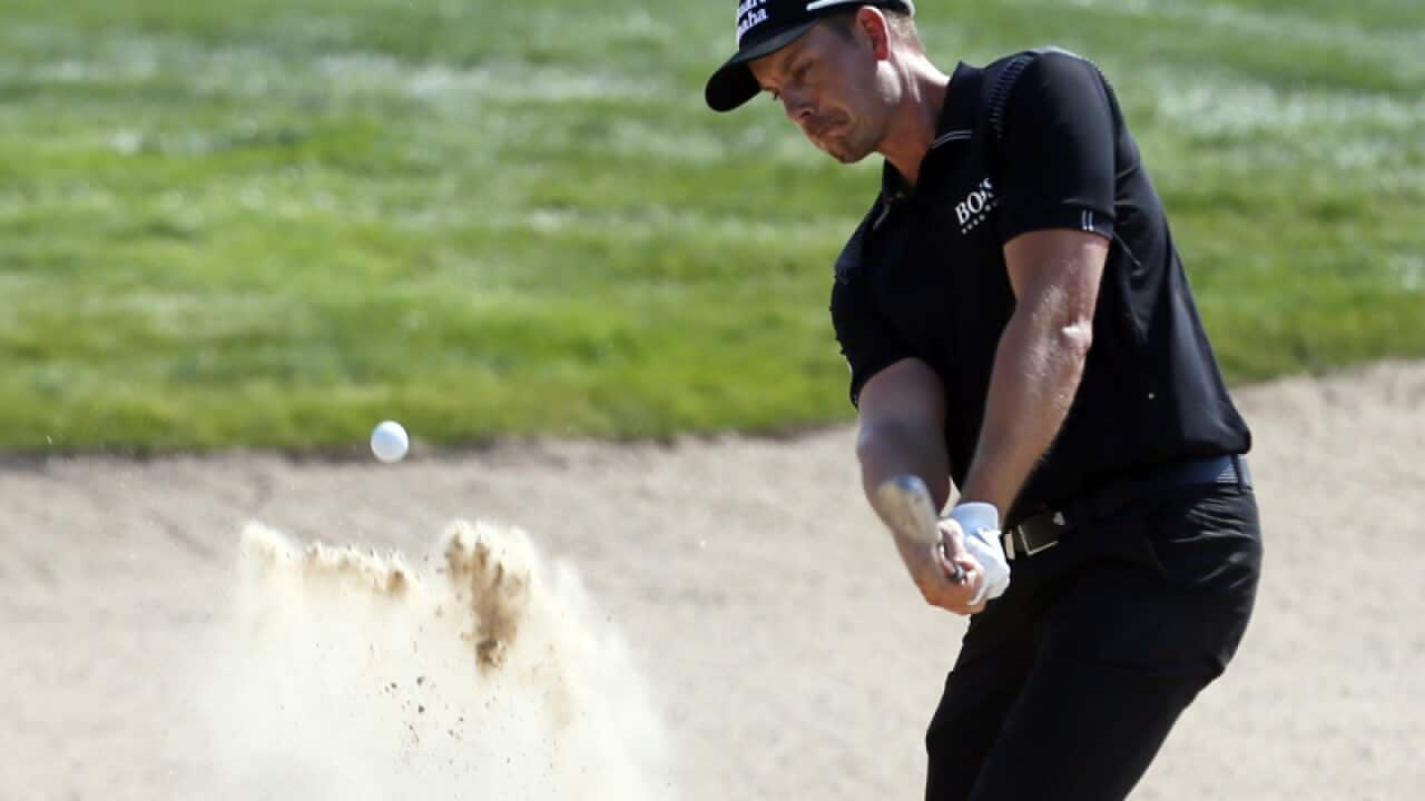 Henrik Stenson plays out of a bunker in Abu Dhabi
