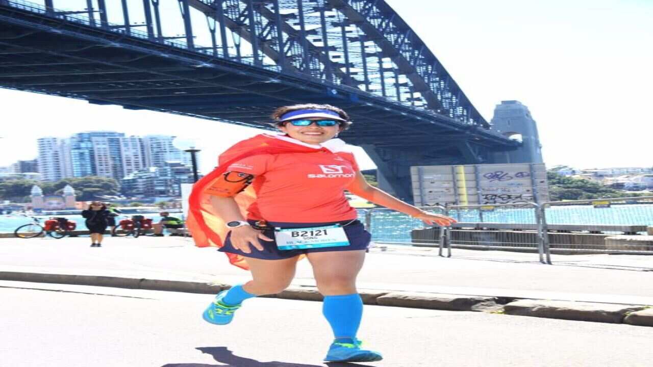 Xiao Song , running with a Chinese national flag