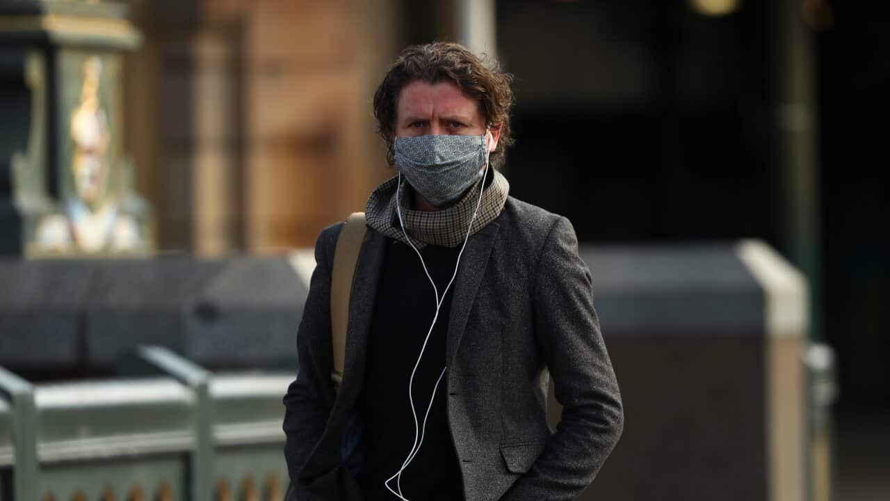 A pedestrian wears a mask in Melbourne on Thursday.