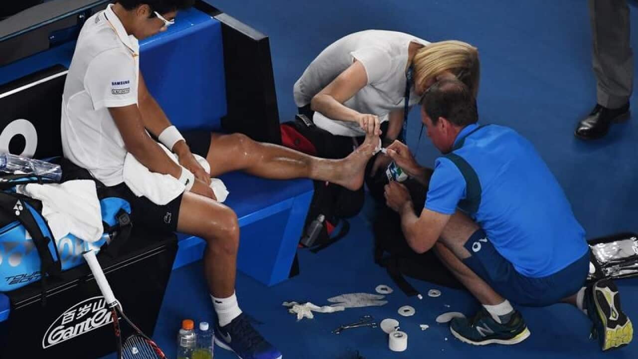 Hyeon Chung of South Korea receives treatment
