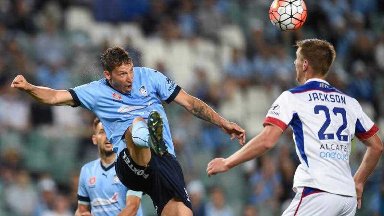 Filip Holosko of Sydney FC heads the ball despite pressure from Lachlan Jackson of the Jets during the round 9 A-League match between Sydney FC and the Newcastle Jets