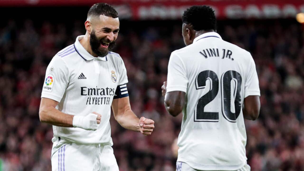 Karim Benzema celebrates a goal with Real Madrid teammate Vinicius Jr.