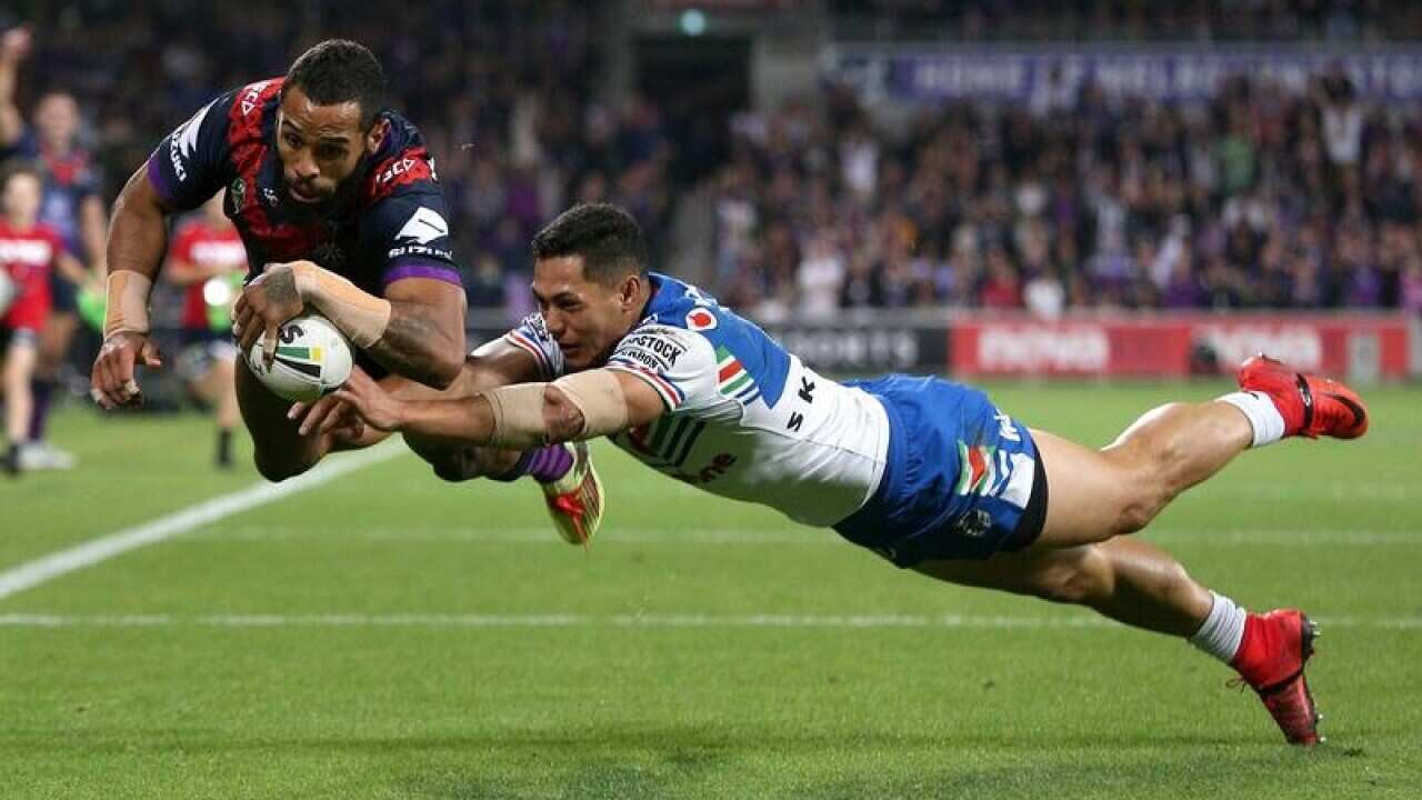 Josh Addo-Carr of the Storm scores a try under pressure.