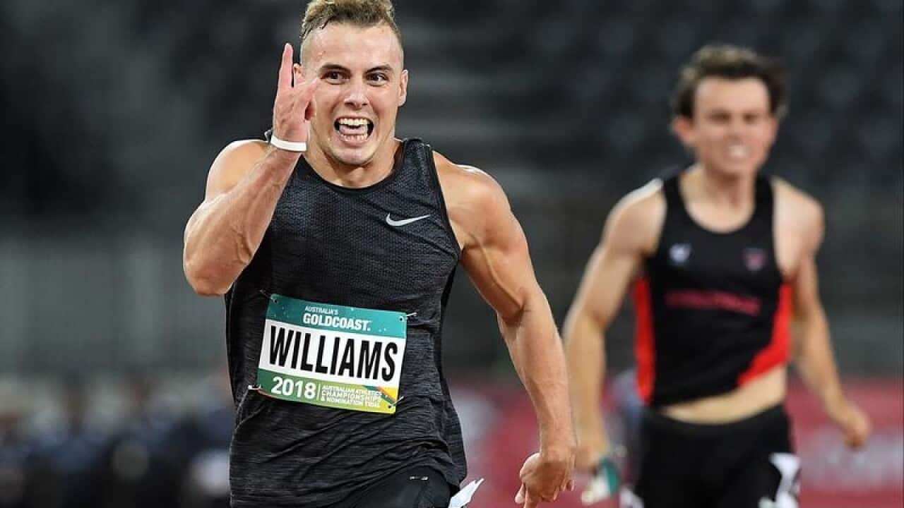 Trae Williams crosses the line to win the Mens 100m Final in QLD.