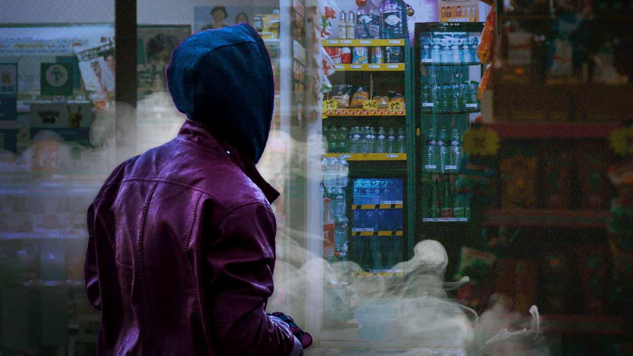Composite image of a hooded person outside a convenience store with smoke drifting across the foreground.