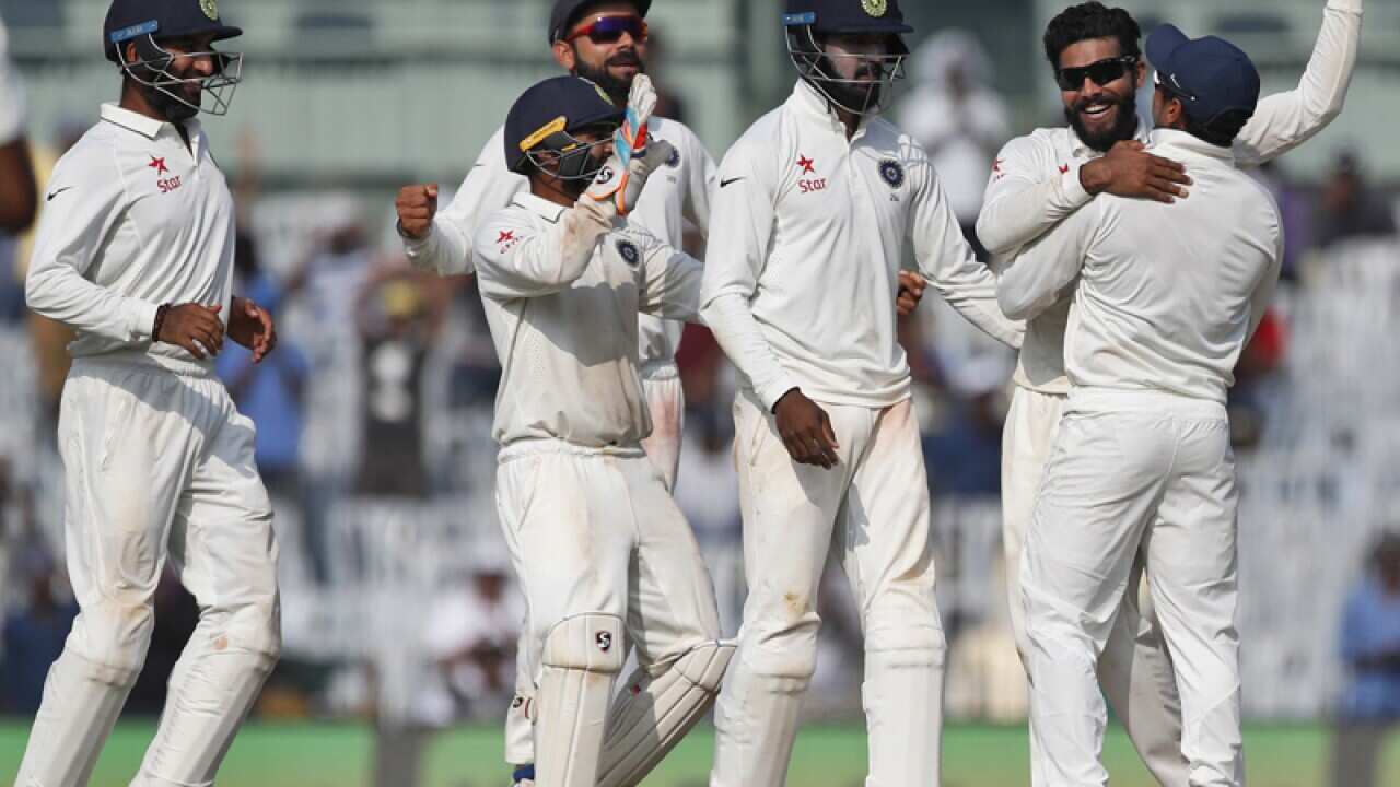 India's Ravindra Jadeja (2R) celebrates after dismissing Ben Stokes