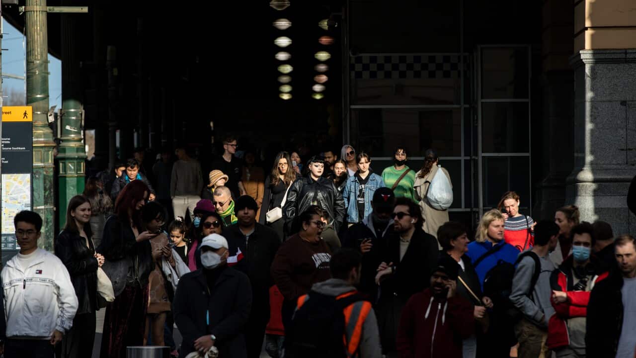 A crowd of people outside a train station