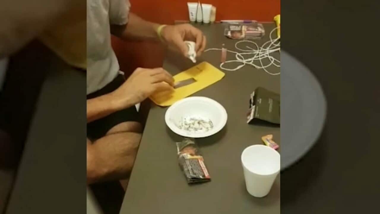 A detainee inside Villawood using drug paraphernalia