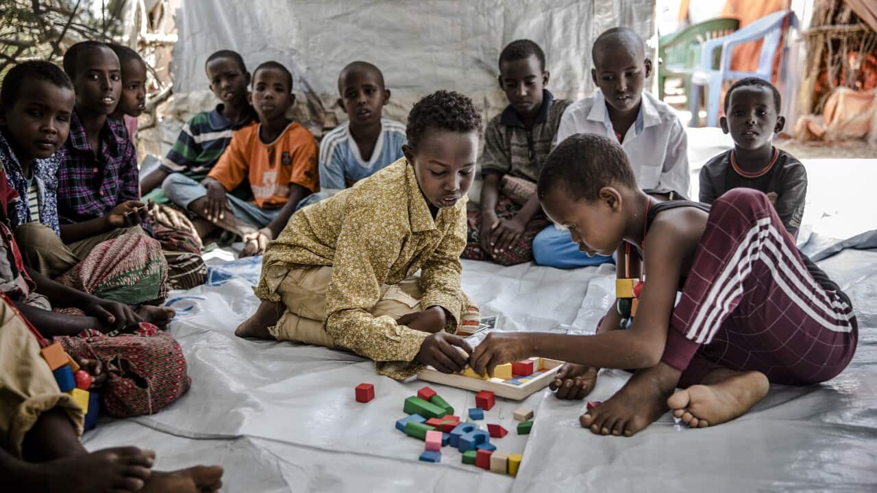 A group of children, forced to leave their homes due to heavy rains and floods, play board games in an UN tent at a camp in Beledweyne, Somalia, December 2019.