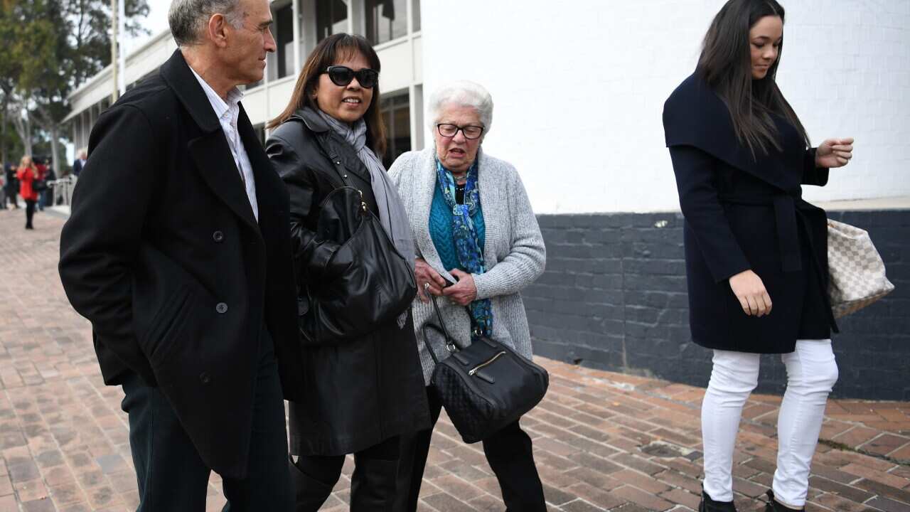 Linda Ellis, the fiancee of Steve Jarvie (2nd left), walks with friends after attending the sentencing of Ben Smith at the Penrith Courthouse in Penrith