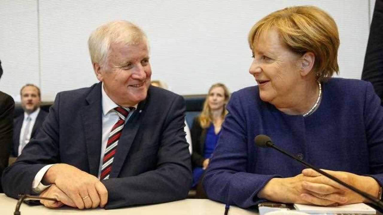 German Chancellor and chairwoman of the Christian Democratic Union (CDU) Angela Merkel (R) and Chairman of the Christian Social Union (CSU) Horst Seehofer (L)attend a CDU/CSU parliamentary group.