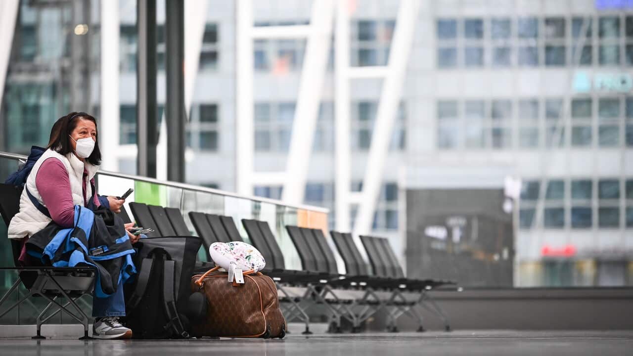 A traveller with a protective mask waits at the airport in Munich, Germany, 27 November 2021.