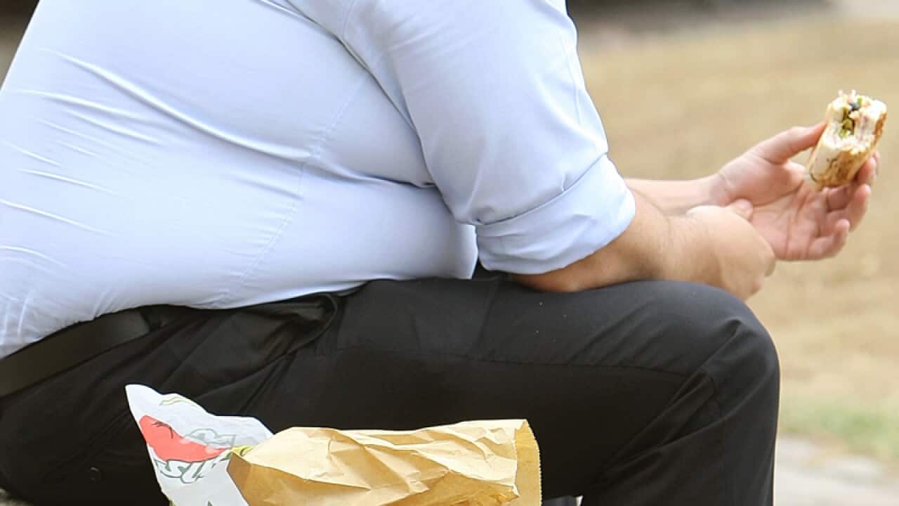 An overweight man eating