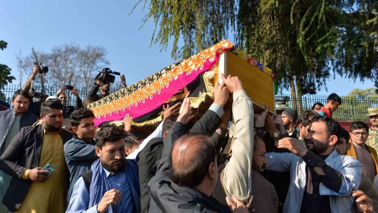 Mourners carry the coffin of female news anchor Malalai Maiwand, who was shot dead by gunmen in Jalalabad on December 10, 2020. (Photo by NOORULLAH SHIRZADA / AFP) (Photo by NOORULLAH SHIRZADA/AFP via Getty Images)