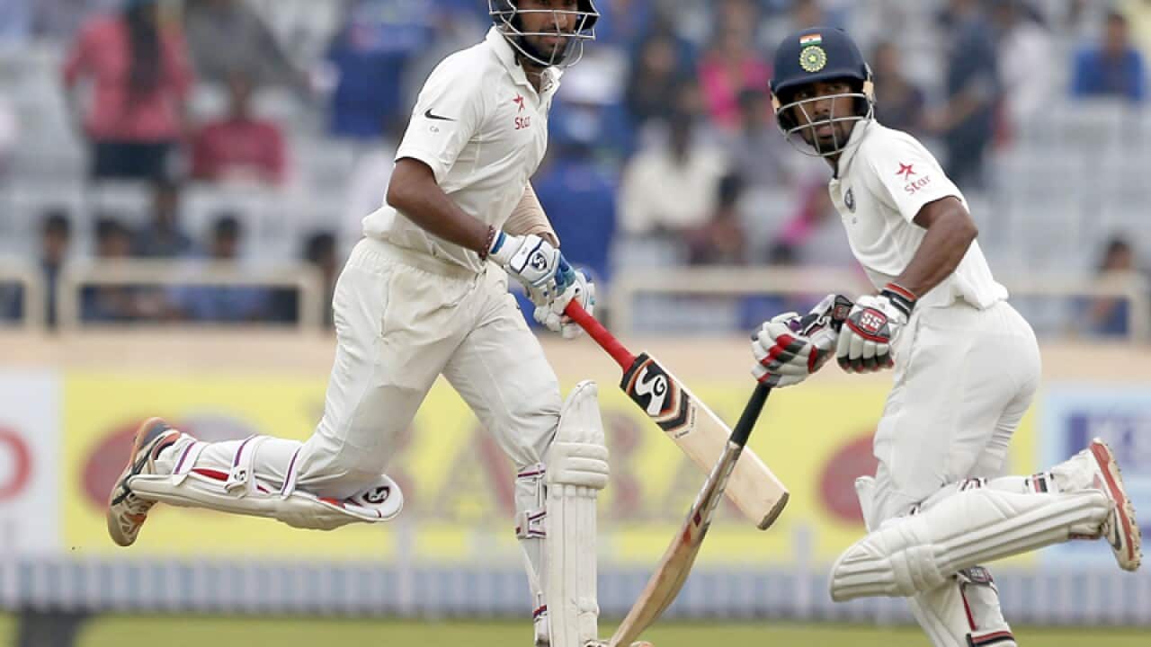 India's Cheteshwar Pujara, left, and Wriddhiman Saha
