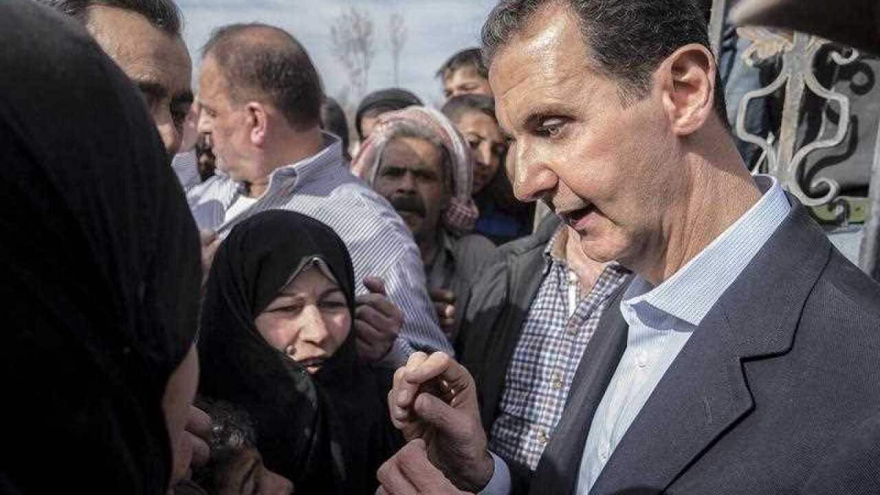 Syrian President Bashar Al-Assad (R) meeting with Syrian citizens, in Eastern Ghouta in Damascus Countryside, Syria, 18 March 2018.