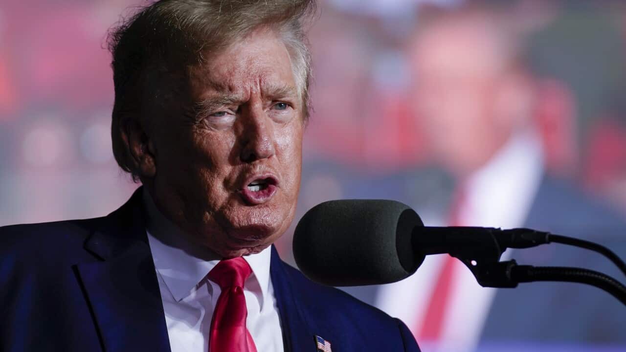 Donald Trump on a podium speaking into a microphone