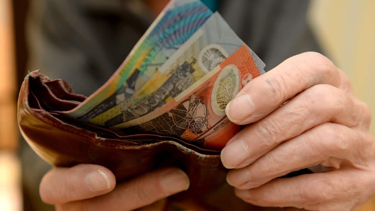 Money is taken out of a wallet Canberra, April 8, 2014. Aged pensions are expected to be hit in the upcoming 2014 budget. (AAP Image/Alan Porritt) NO ARCHIVING
