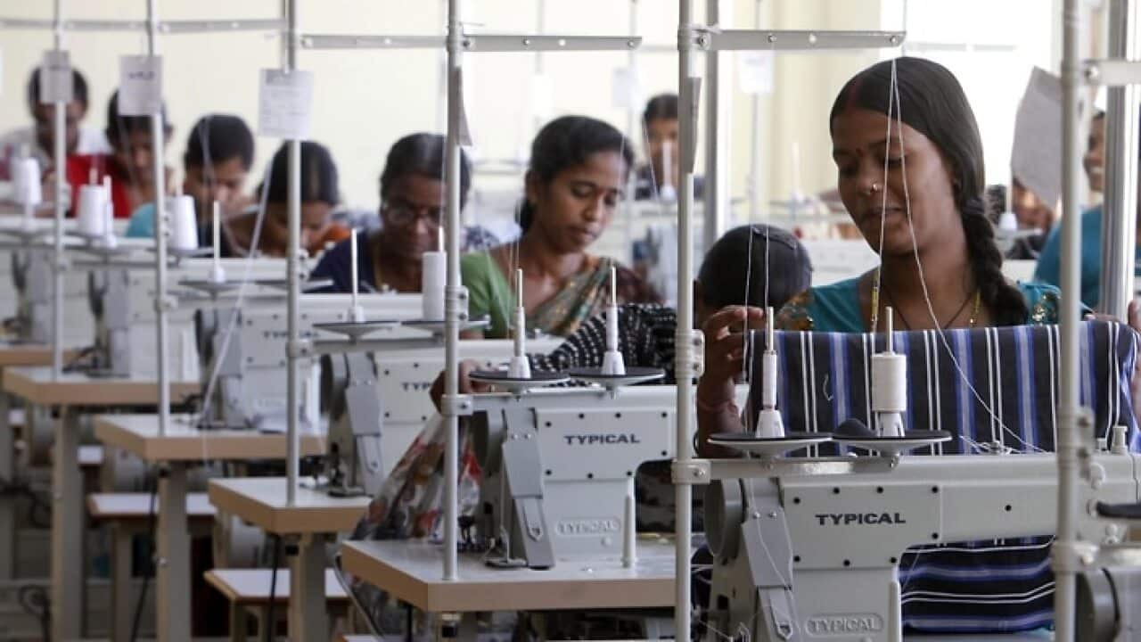 Indian workers sew at a garment factory on the outskirts of Hyderabad, India, Friday, Oct. 12, 2012.