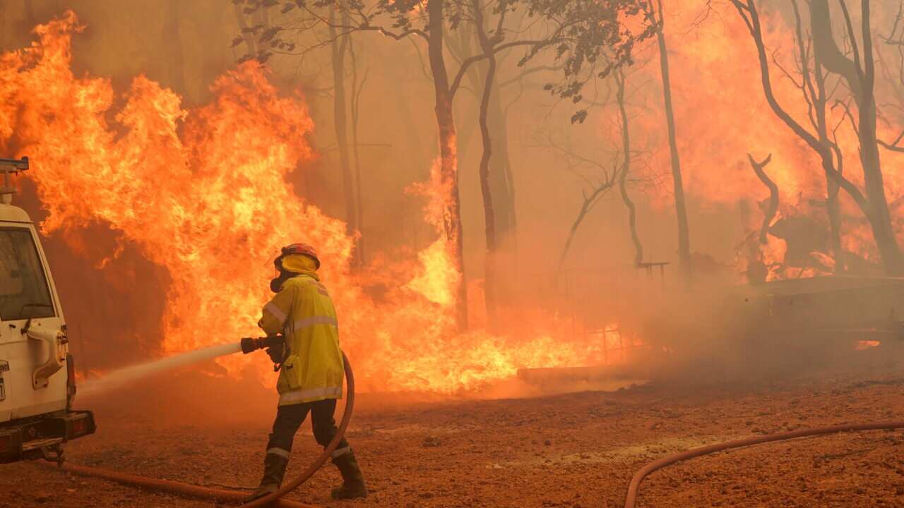 A firefighter attends a fire near Wooroloo, north east of Perth, Australia, on 2 February.