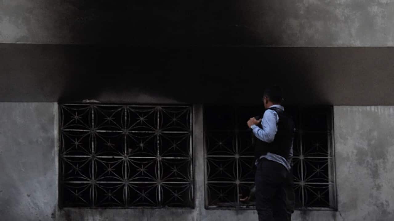 Security forces check a building after an explosion was heard while Venezuelan President Nicolas Maduro was attending a ceremony.
