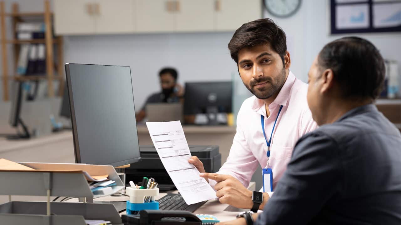 Customer with bank manager in office stock photo