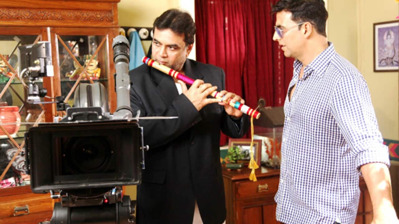: Film's lead actor Paresh Rawal (in black) along with his co-star Akshay Kumar on the sets of the 2012 film Oh My God!