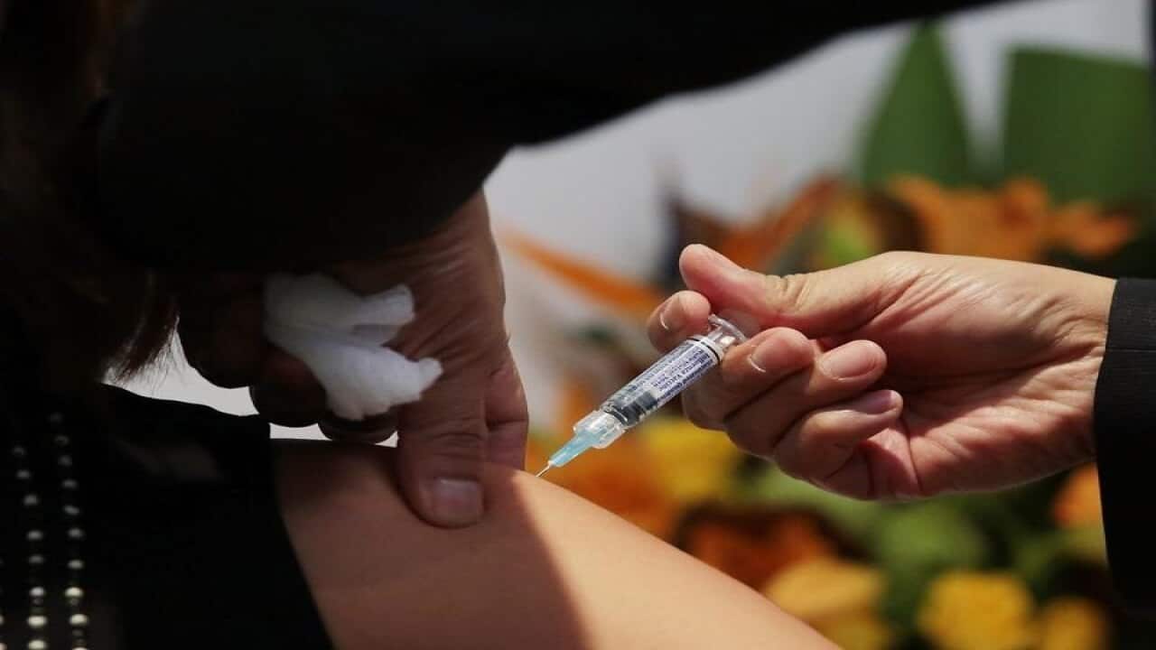 A member of the public receives a flu shot.
