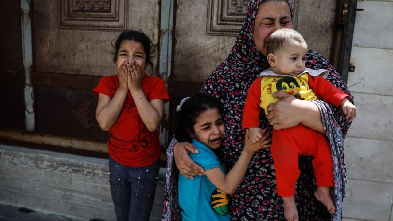 Palestinian women and children evacuated their homes and headed for shelter during an Israeli airstrike in Gaza City on 20 May..