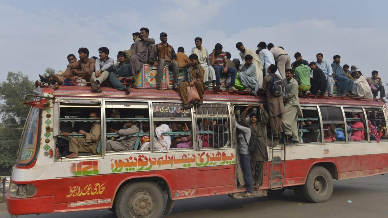 File image of Pakistani passengers travelling on a bus to return to their homes ahead of the Eid al-Adha festival in September last year.