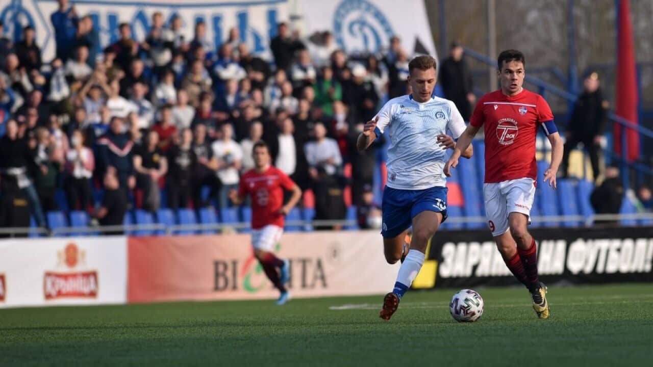 FC Minsk and FC Dinamo-Minsk team players vie for the ball during the Belarus Championship football match in Minsk