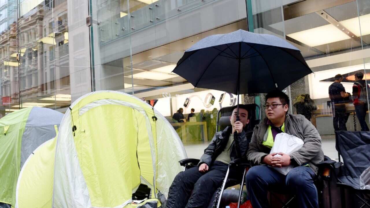 Customers queued outside the Sydney Apple Store.
